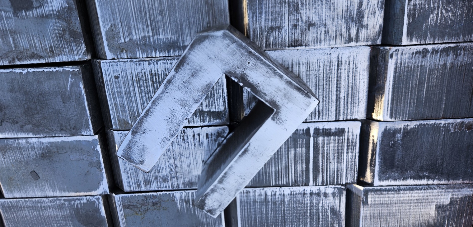 Top angle of multiple steel parts that were flame cut.